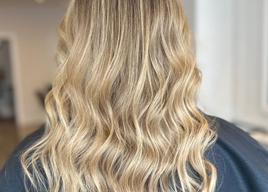 Blonde wavy hair styled at Joseph Rotchford Hair, Harrogate, England, GB salon for a glossy finish.