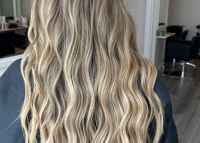 Luxurious wavy blonde hair at Joseph Rotchford Hair, Harrogate, England, GB.