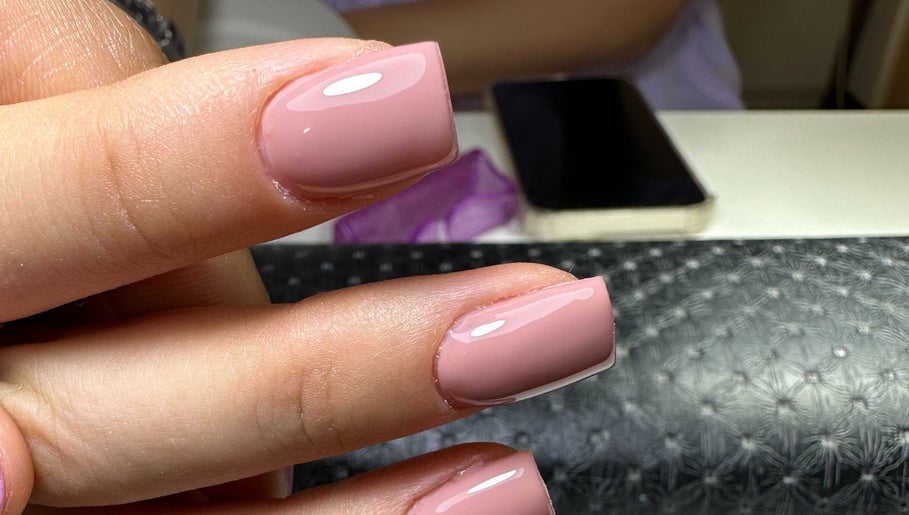 Elegant manicured nails at Nailina Ny, Scarsdale, New York, US showcasing a perfect pink polish.