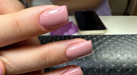 Elegant manicured nails at Nailina Ny, Scarsdale, New York, US showcasing a perfect pink polish.