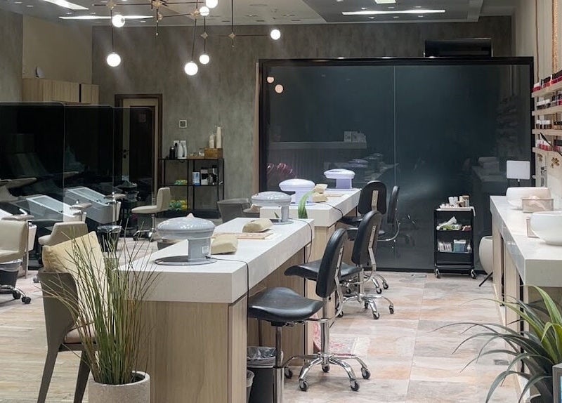 Interior of Mubrad Salon صالون مبرد in الدمام, SA, featuring sleek styling stations and modern decor.
