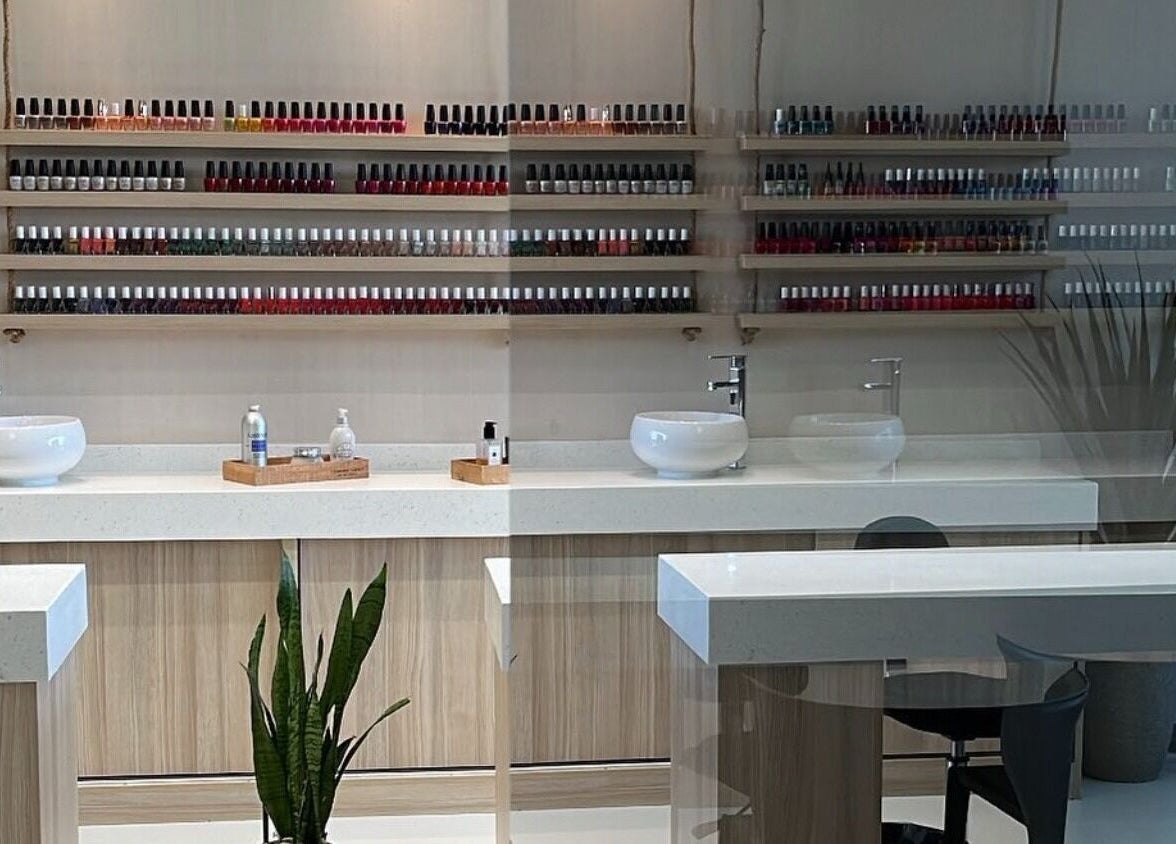 Elegant nail polish shelves at Mubrad Salon صالون مبرد, الدمام, SA, showcasing a clean, modern manicure station.