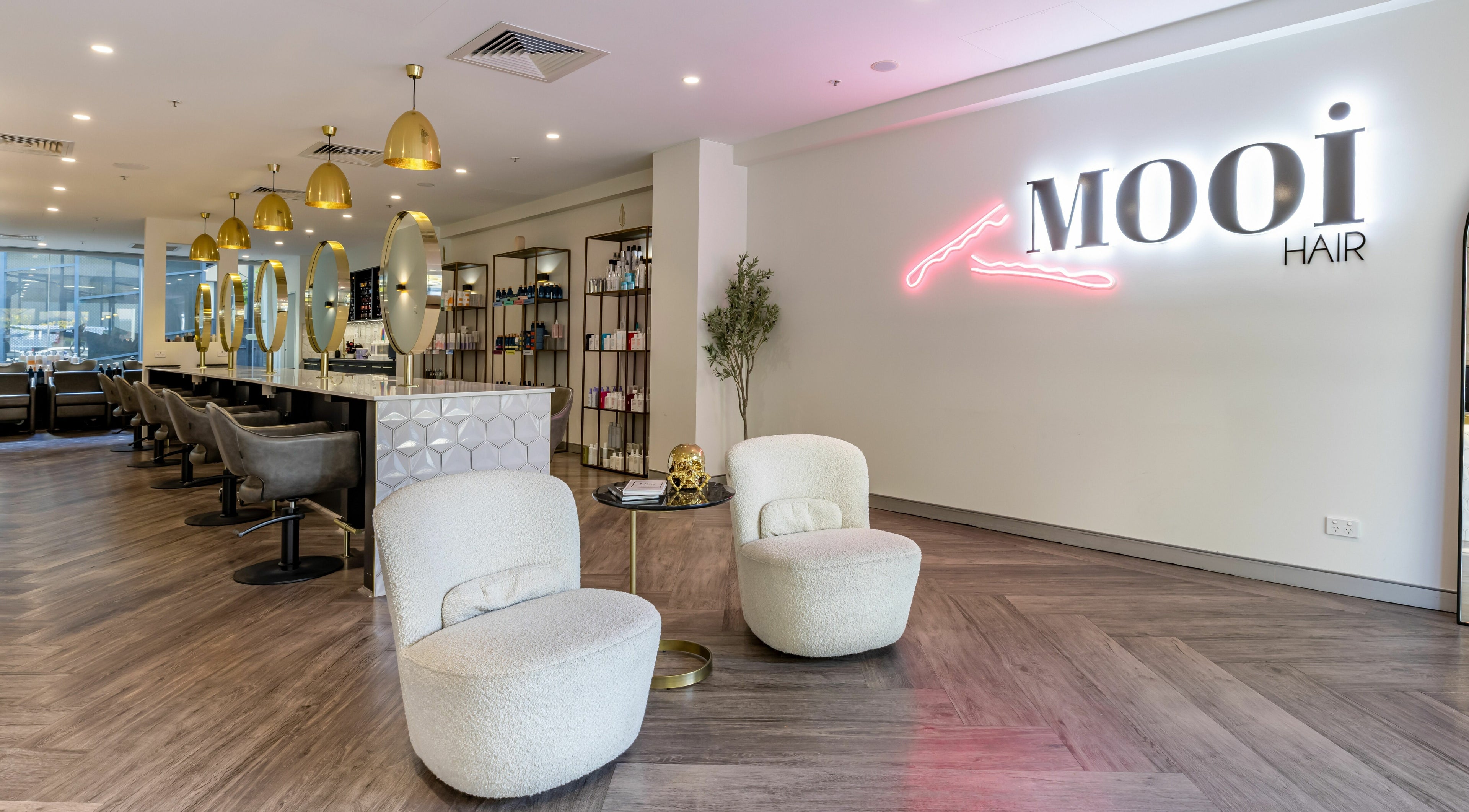 Chic interior of Mooi Hair CBR in Canberra, AU, showcasing modern seating and stylish decor.