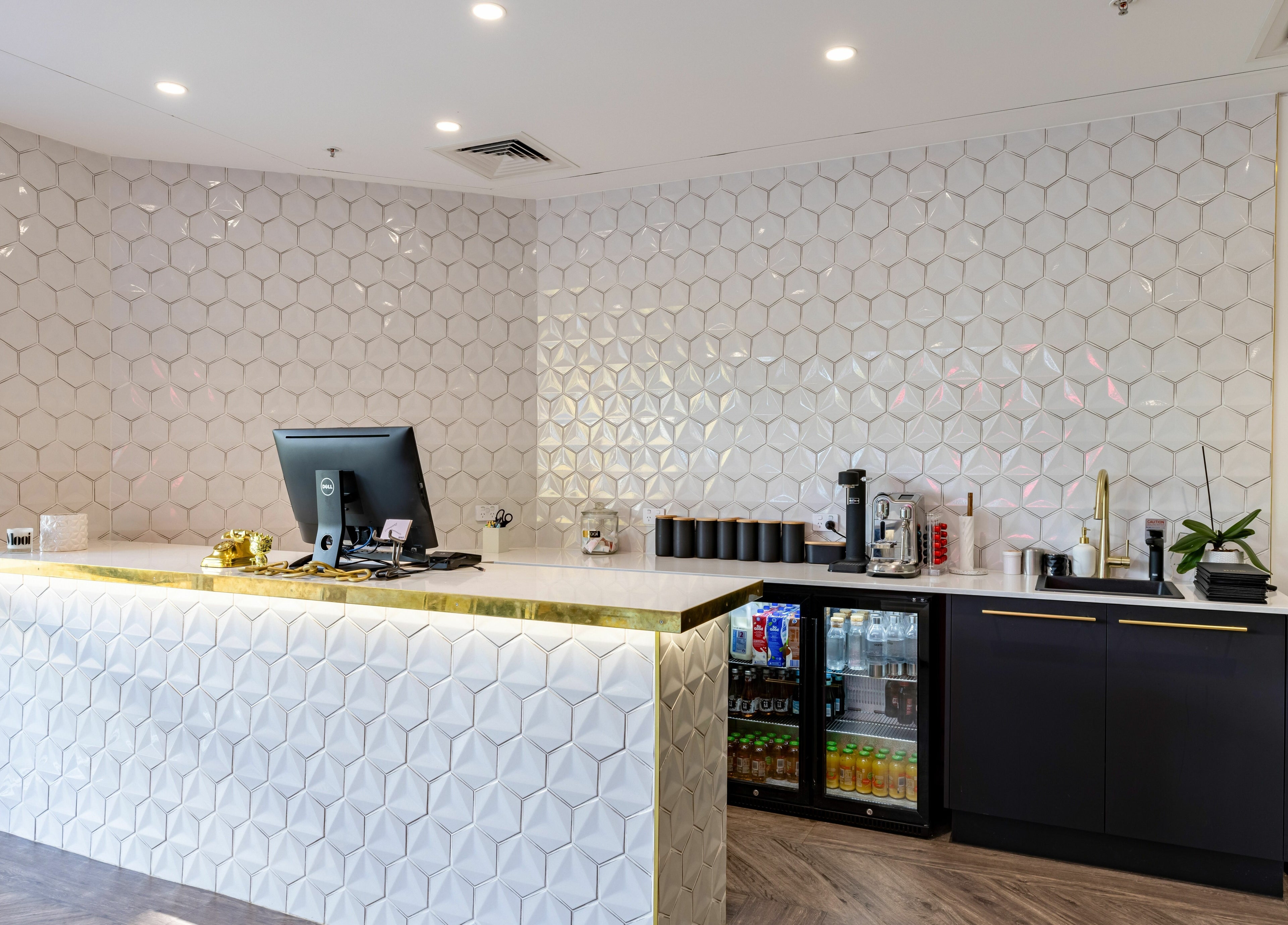 Reception area at Mooi Hair CBR, Canberra, AU with modern decor and beverage setup.