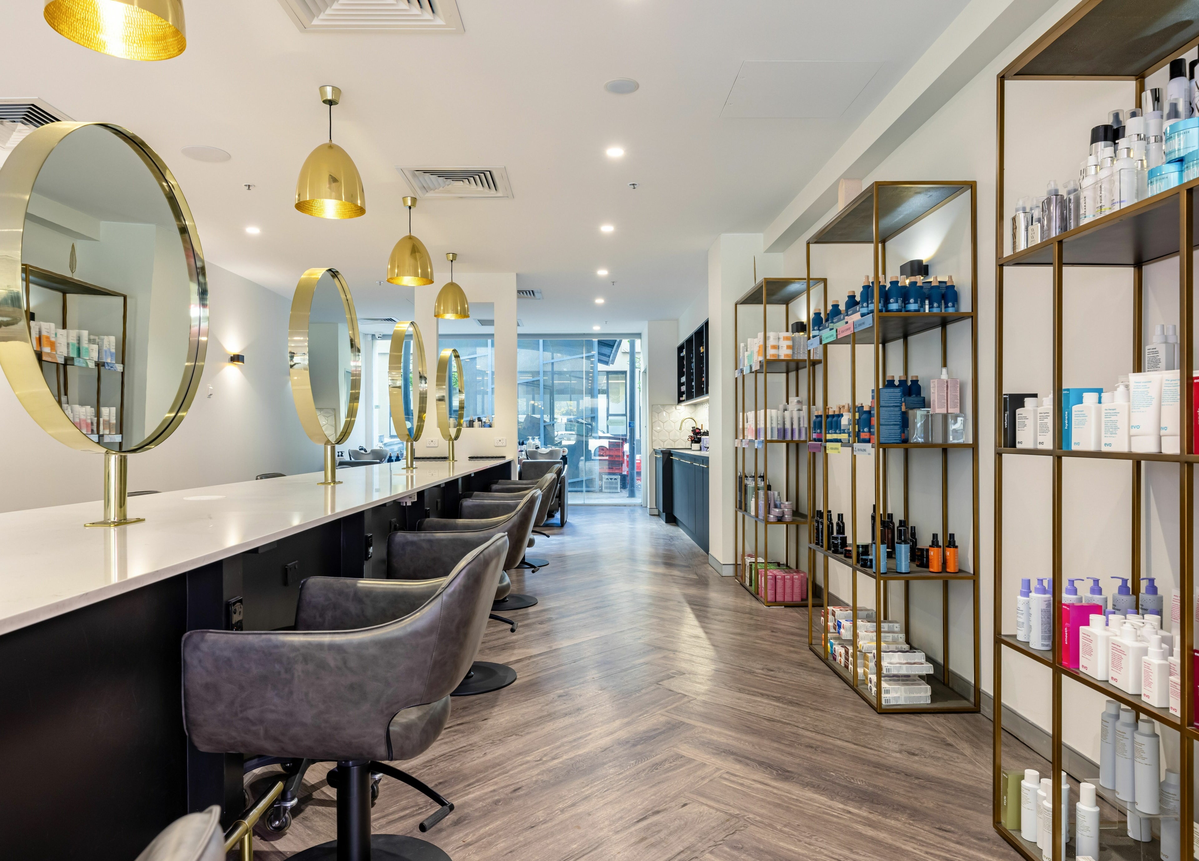 Modern salon interior at Mooi Hair CBR, Canberra, Australian Capital Territory, AU with products and gold accents.
