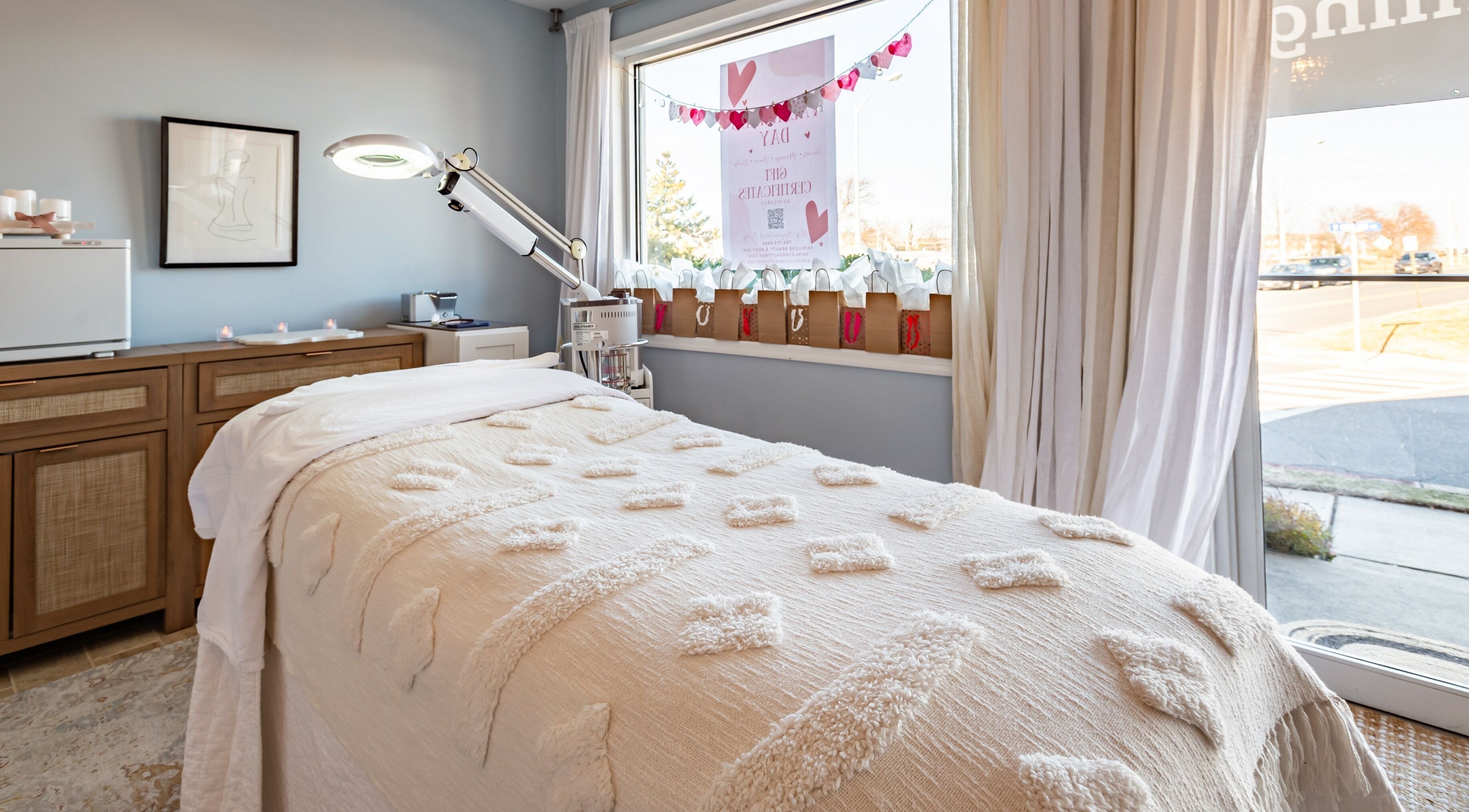 Cozy treatment room at Skin Love Beauty & Body Bar, Atlantic Highlands, New Jersey, US, featuring a plush bed.