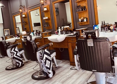 Modern interior of Vauxhall Barbers, London, England, GB showing stylish chairs and sinks.