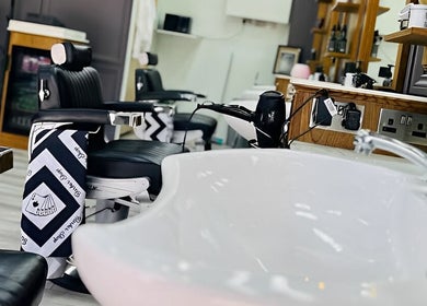 Sleek interior of Vauxhall Barbers in London, England, GB featuring modern barber chairs and amenities.