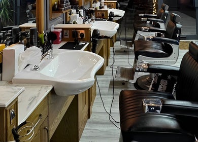 Elegant barber chairs at Vauxhall Barbers, London, England, GB, showcasing modern interior design.