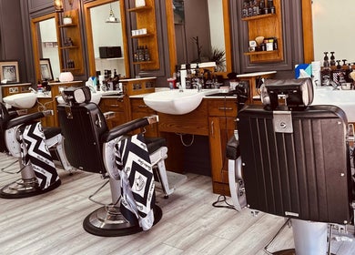 Modern barber chairs at Vauxhall Barbers, London, England, GB showcasing a stylish interior.