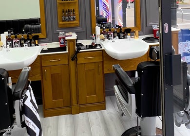 Inside Vauxhall Barbers in London, England, GB; showcases modern barber chairs and grooming stations.
