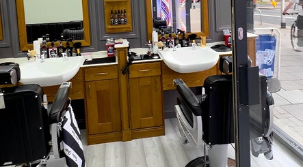 Inside Vauxhall Barbers in London, England, GB; showcases modern barber chairs and grooming stations.