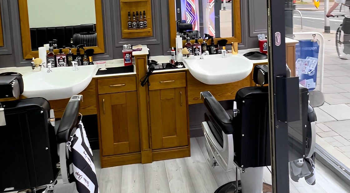 Inside Vauxhall Barbers in London, England, GB; showcases modern barber chairs and grooming stations.