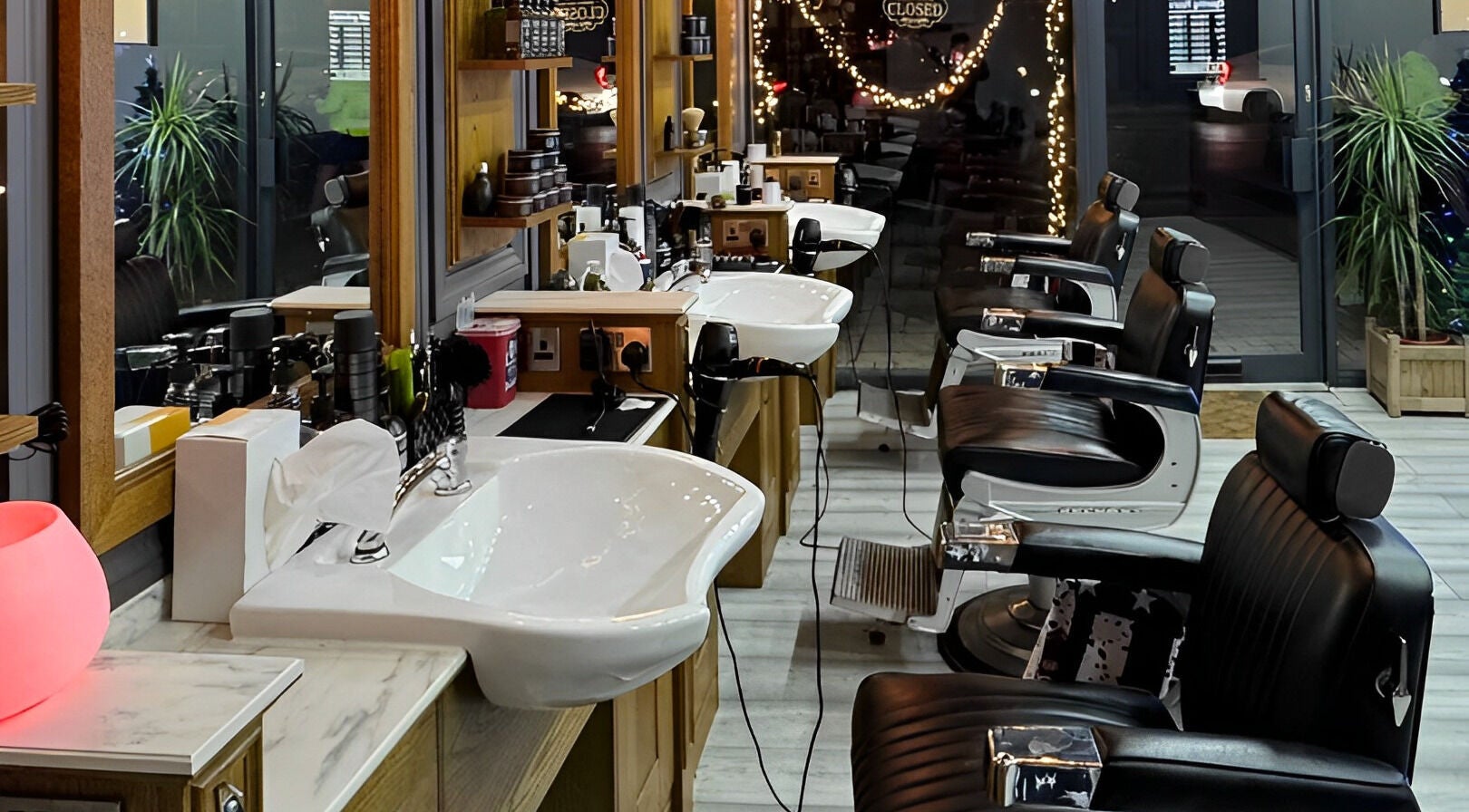Vauxhall Barbers in London, England, GB features sleek chairs and well-lit modern decor, offering a refined grooming space.