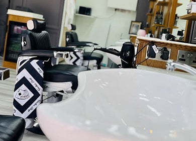 Elegant barber chairs and stylish sink at Vauxhall Barbers, London, England, GB.
