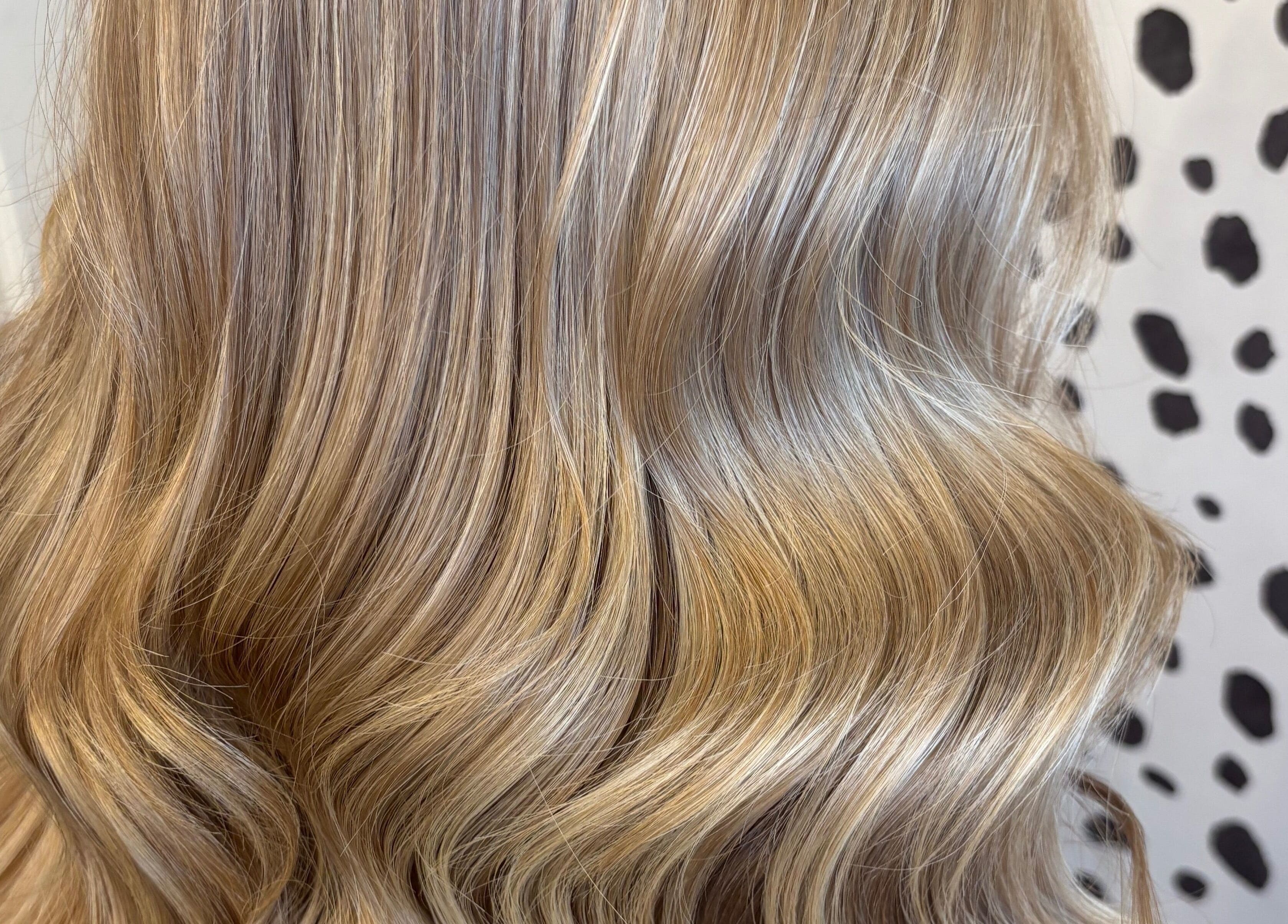Elegant blonde waves styled at Justine’s Hair and Barbering in Elgin, Scotland, GB showcasing expert hair techniques.