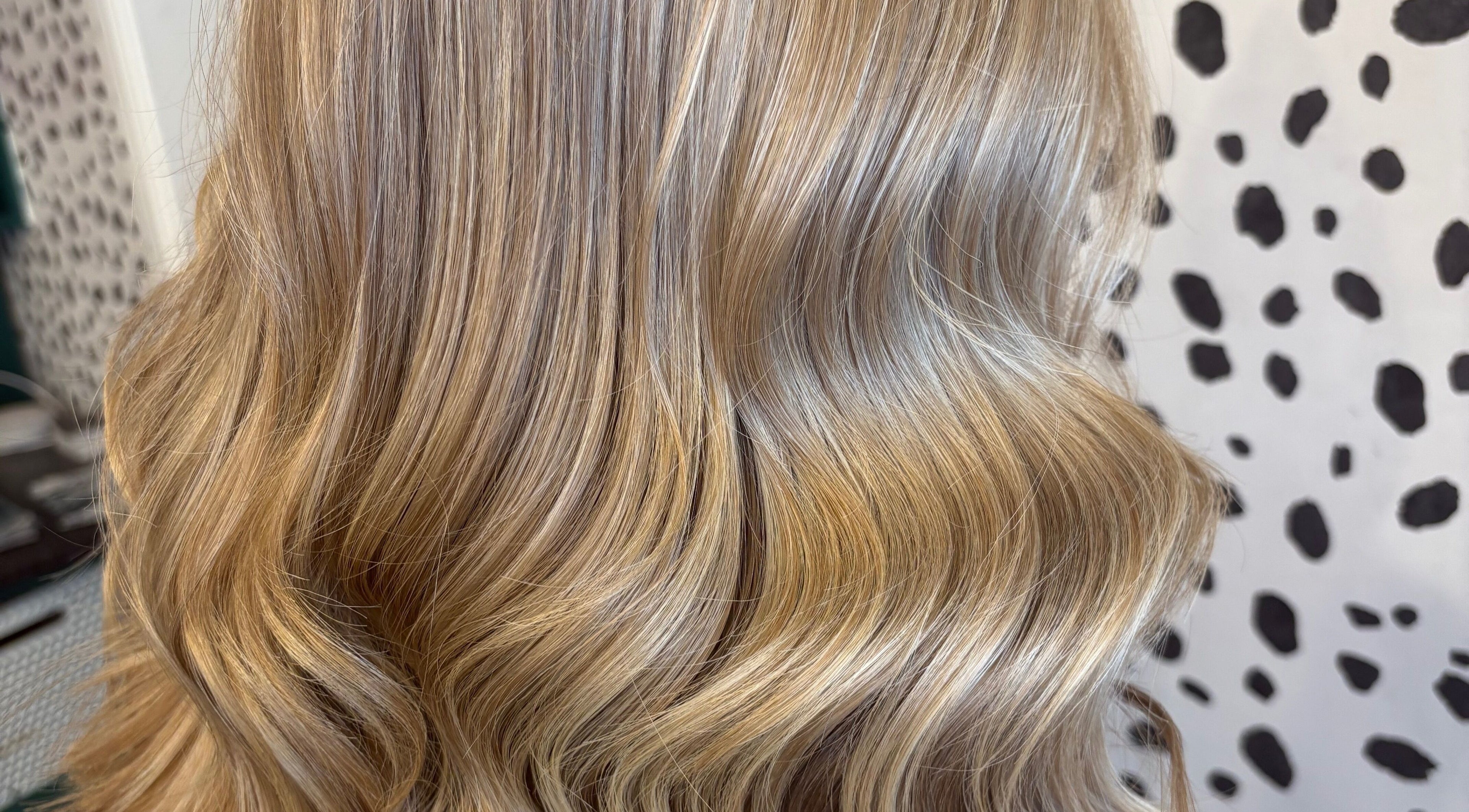 Elegant blonde waves styled at Justine’s Hair and Barbering in Elgin, Scotland, GB showcasing expert hair techniques.