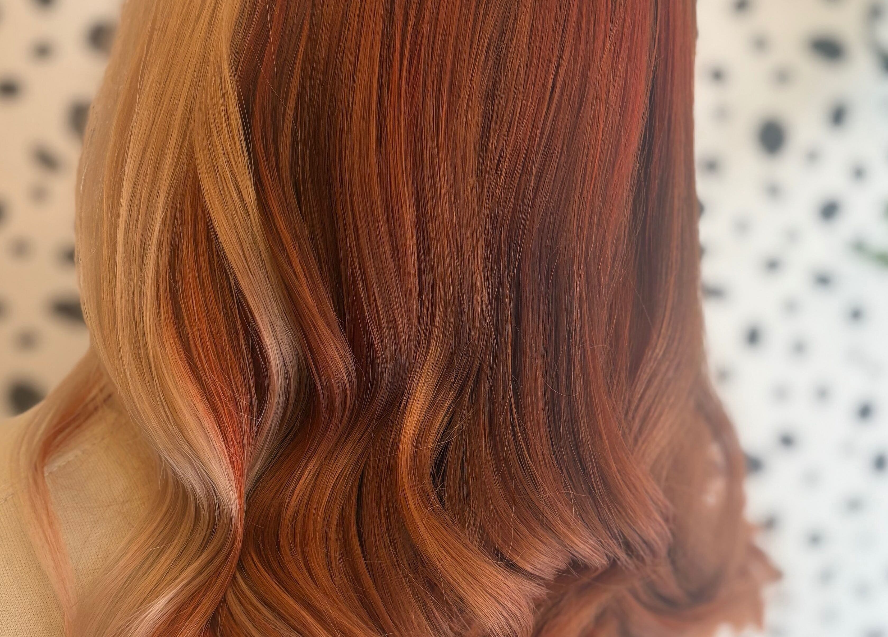 Elegant red hair waves styled professionally at Justine’s Hair and Barbering, Elgin, Scotland, GB.