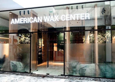 Front view of AMERICAN WAX CENTER with glass facade in Dubai, Dubai, AE, showcasing modern design.