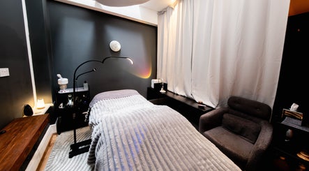 Relaxing treatment room at Studio Luune, London, England, GB, featuring cozy decor and a luxurious treatment bed.
