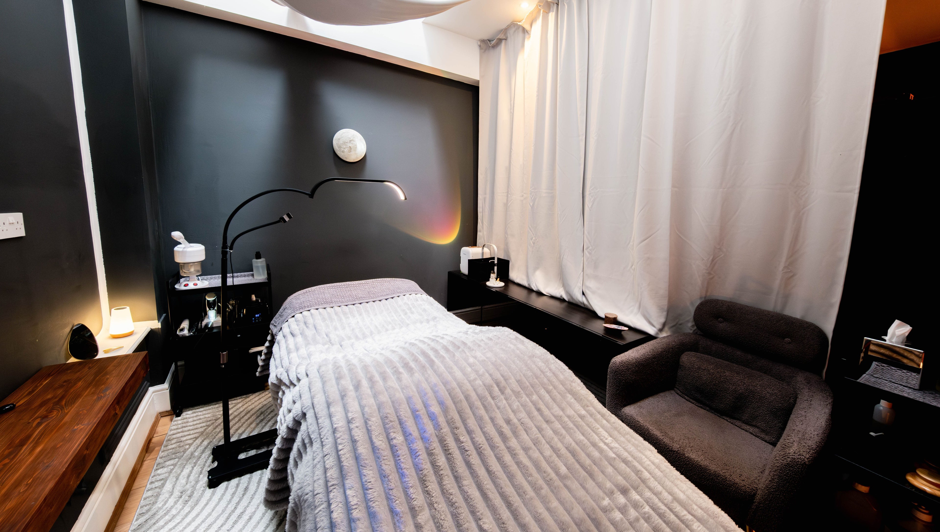 Relaxing spa room at Studio Luune, London, England, GB with plush chair and ambient lighting.