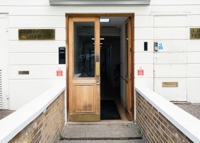 Entrance to Studio Luune in Hurlingham Studios, London, England, GB featuring wooden doors and modern design.