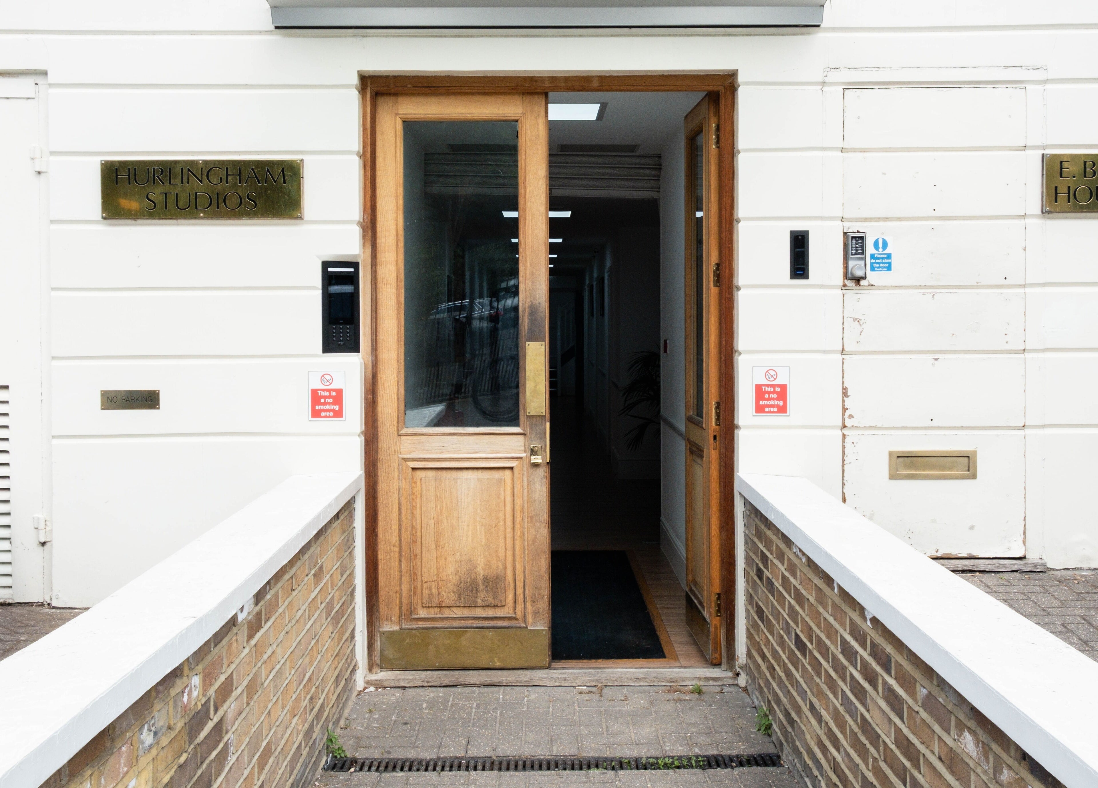 Entrance to Studio Luune in Hurlingham Studios, London, England, GB featuring wooden doors and modern design.