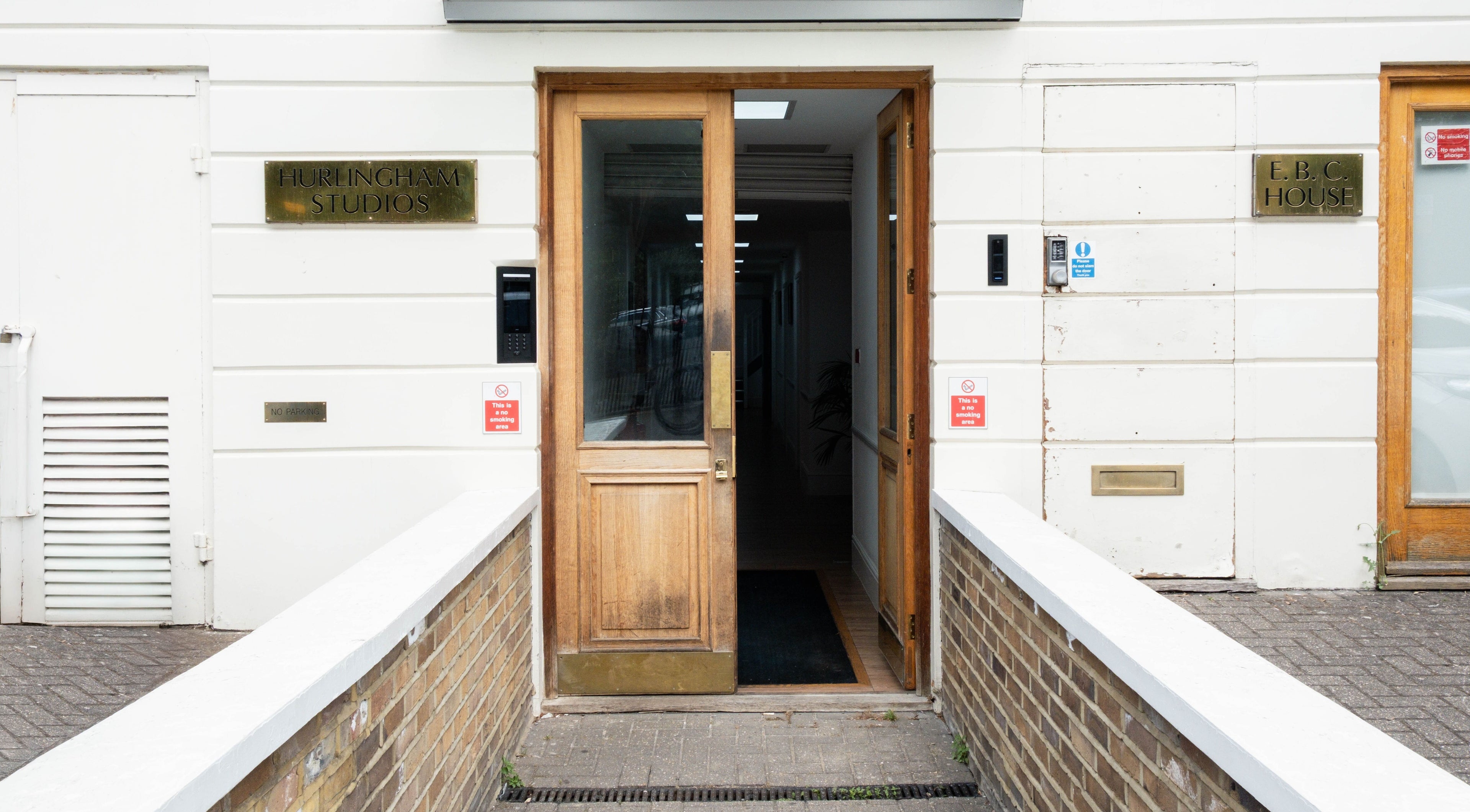 Entrance to Studio Luune in Hurlingham Studios, London, England, GB featuring wooden doors and modern design.
