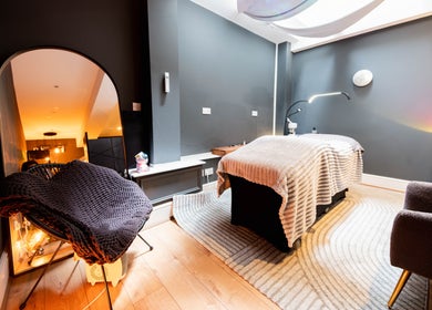 Cozy spa room at Studio Luune in London, England, GB, featuring a treatment bed and ambient lighting.