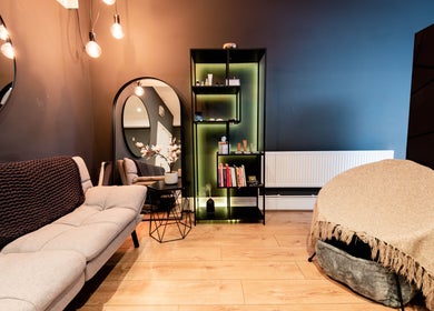 Cozy interior of Studio Luune with elegant decor in London, England, GB. Features a soft sofa and ambient lighting.