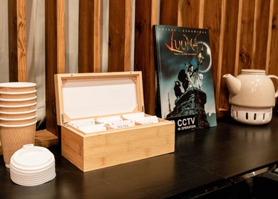 Tea setup at Studio Luune, London, England, GB with cups, teapot, and tea box on a wooden shelf.