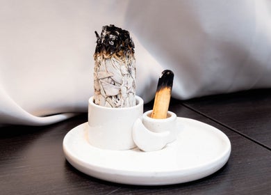 White ceramic tray with sage and palo santo at Studio Luune, London, England, GB for a calming wellness experience.