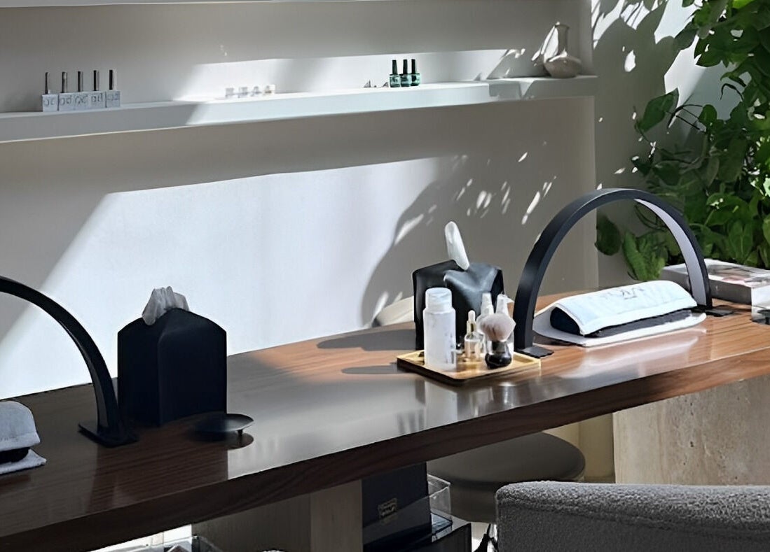 Elegant spa desk at Nola Head Spa and Salon, Riyadh, Riyadh Province, SA, with lush greenery and soothing products.