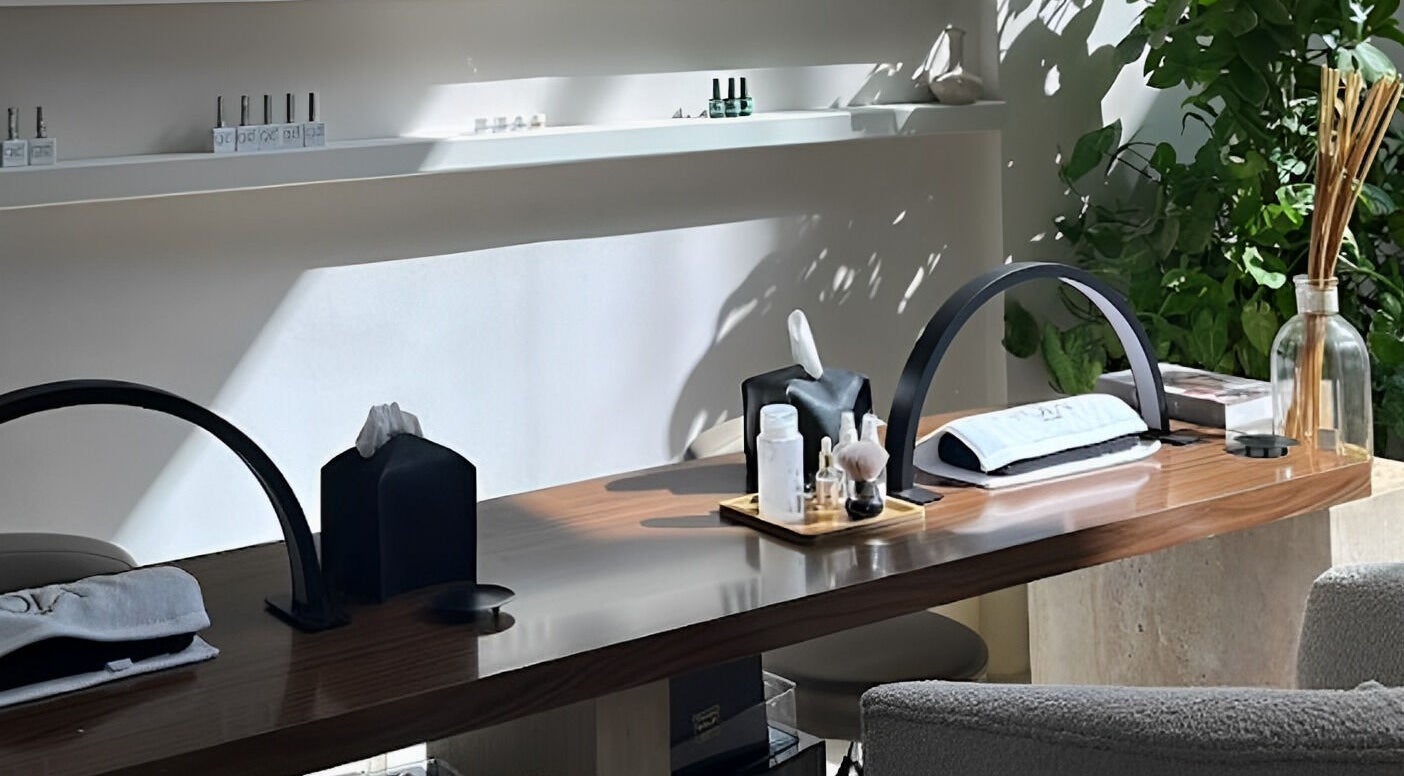 Elegant spa desk at Nola Head Spa and Salon, Riyadh, Riyadh Province, SA, with lush greenery and soothing products.
