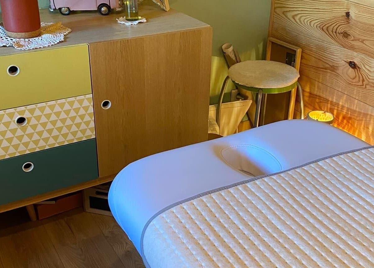Massage table at Au Chalet Zen, Bonson, Auvergne-rhône-alpes, FR, offering relaxing wellness atmosphere.