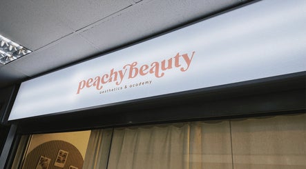 Exterior of HIME STUDIO / He Mēi “姫” in Singapore, SG, featuring Peachy Beauty Aesthetics & Academy sign.