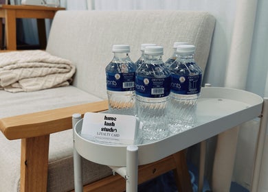 Comfortable seating with water bottles at HIME STUDIO / He Mēi “姫” Singapore, SG for a relaxing experience.