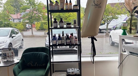 Product display at Lahives Glamsquad 4 Ivy Farm Court, Hale showcasing beauty items and comfy seating.