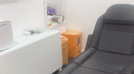 Modern treatment room at Enhanced Aesthetics Scotland in Glasgow, Scotland, GB with sleek furniture.