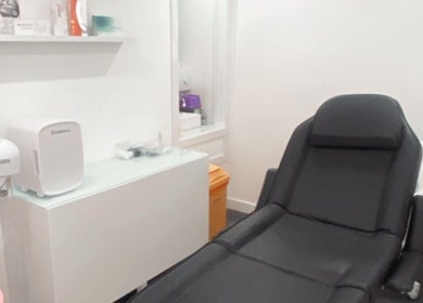 Modern treatment room at Enhanced Aesthetics Scotland, Glasgow, Scotland, GB, featuring a sleek chair.