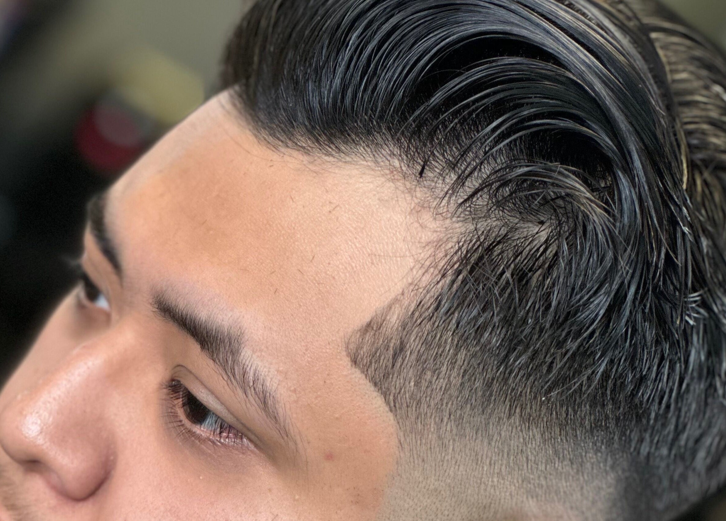 Modern sleek haircut at THE GRO GALLERY. INC., Shelby, North Carolina, US showcasing detailed fade.