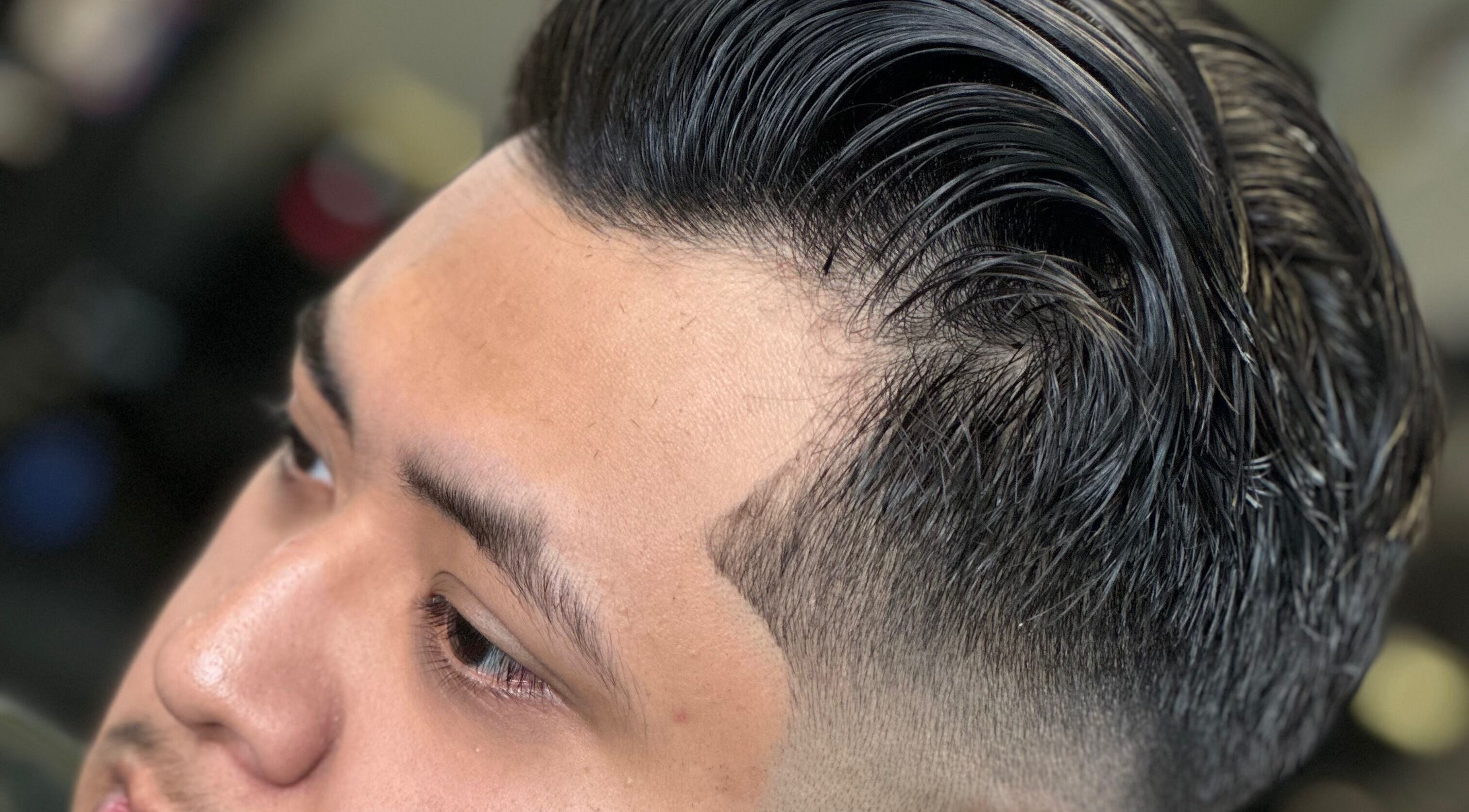 Modern sleek haircut at THE GRO GALLERY. INC., Shelby, North Carolina, US showcasing detailed fade.