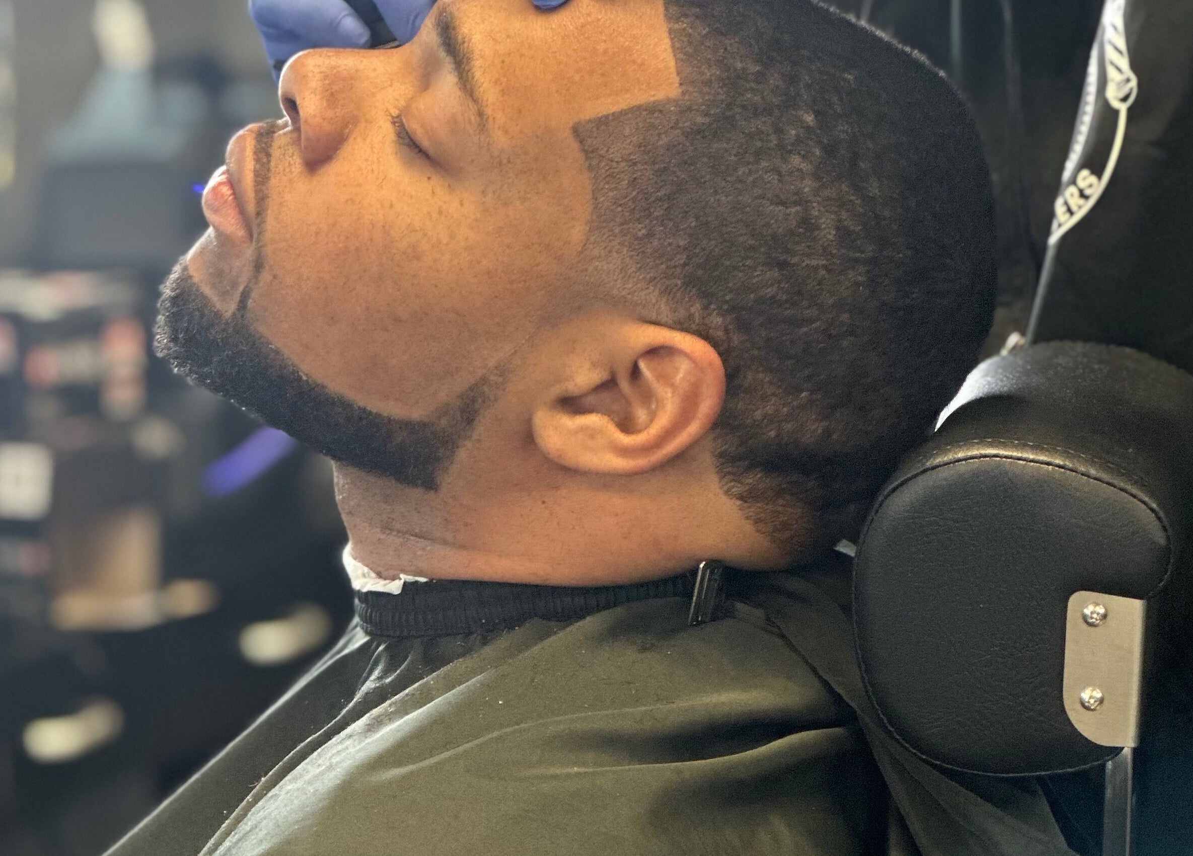 Man receiving a precise haircut at THE GRO GALLERY. INC., Shelby, North Carolina, US.