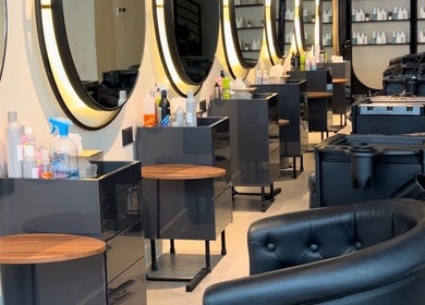 Modern interior of Lilyas Beauty Salon, Al Khobar, Eastern Province, SA, showcasing styling stations and chairs.