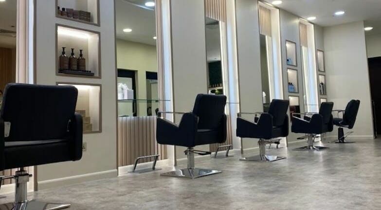 Modern salon chairs and stations at The M Beauty Salon, Dubai, AE, showcasing stylish interior design.