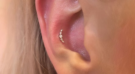 Elegant ear piercing at Thirteen Roses • Piercing by Danielle in Broxburn, Scotland, GB showcasing delicate design.