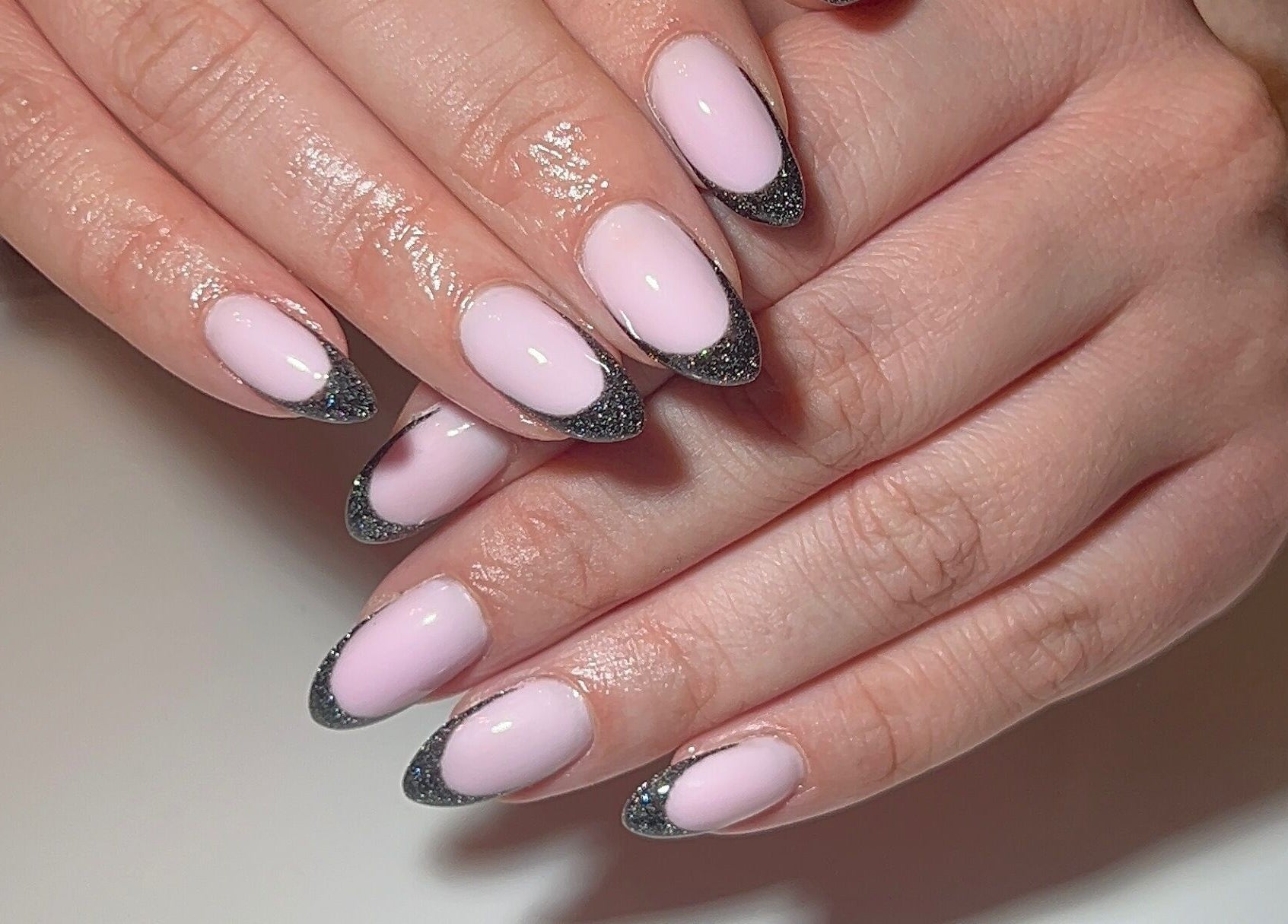 Stylish pink and black glitter nails at Dunn Up By Alexandra, Middlesbrough, England, GB.