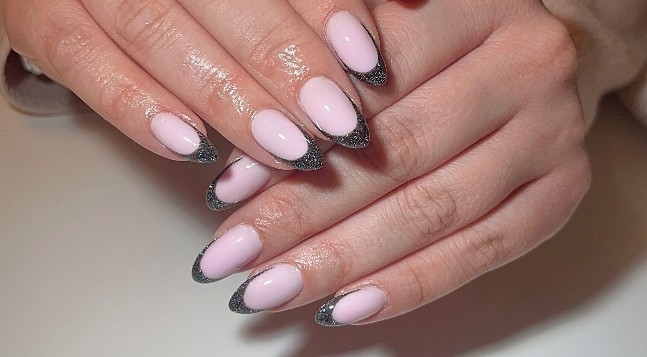 Stylish pink and black glitter nails at Dunn Up By Alexandra, Middlesbrough, England, GB.