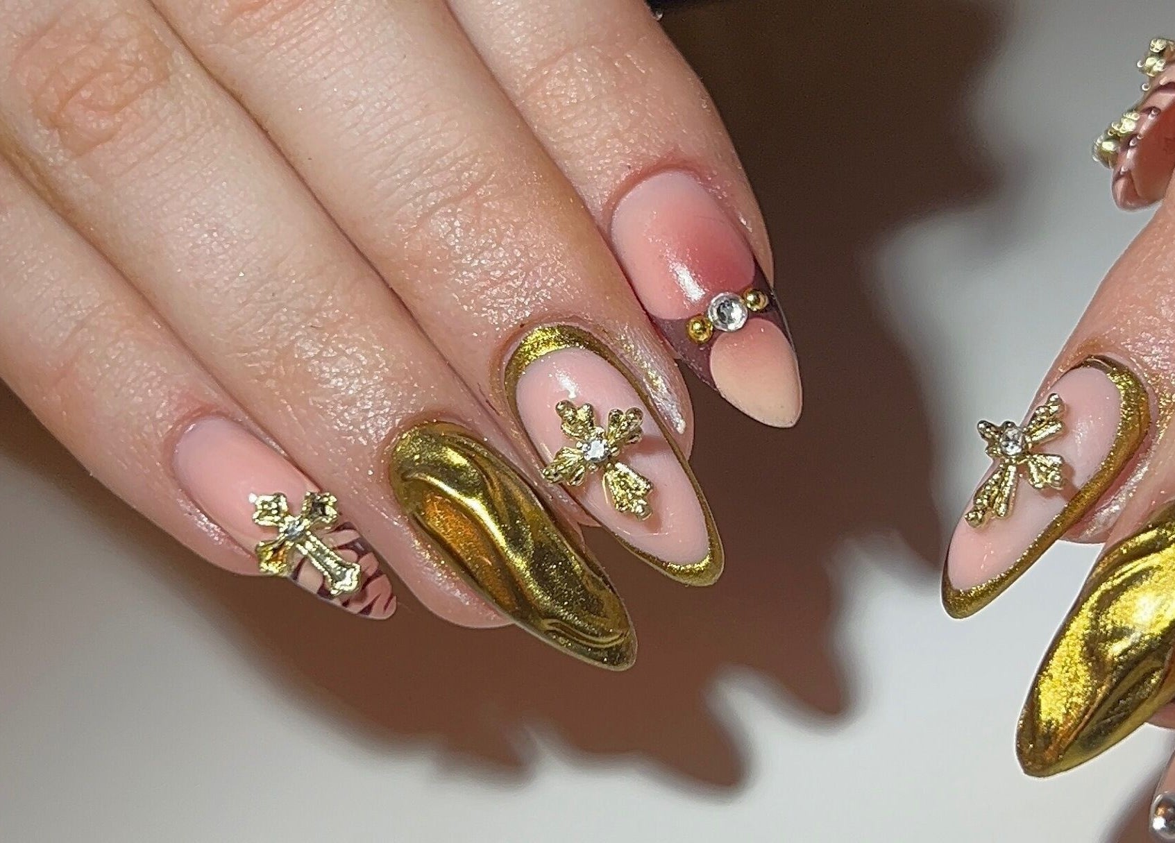 Detailed gold nail art at Dunn Up By Alexandra, Middlesbrough, England, GB.