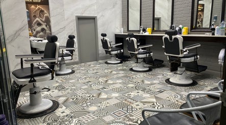 Stylish interior of Broadway Barbershop in Ultimo, NSW, AU with vintage barber chairs and decorative flooring.